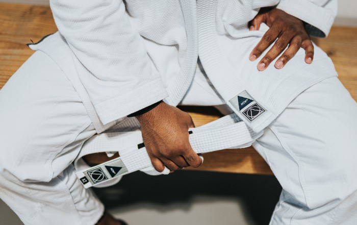 white belt competitor resting.