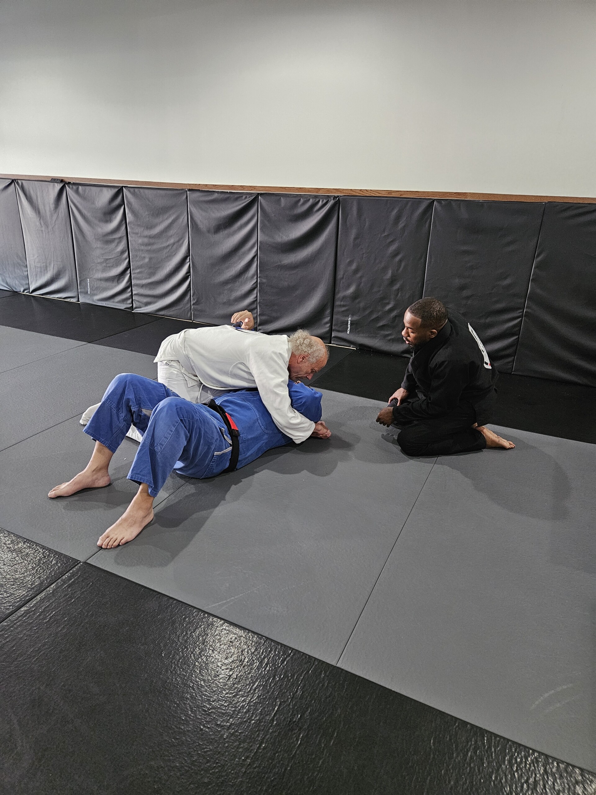 Instructor kneeling and helping students.