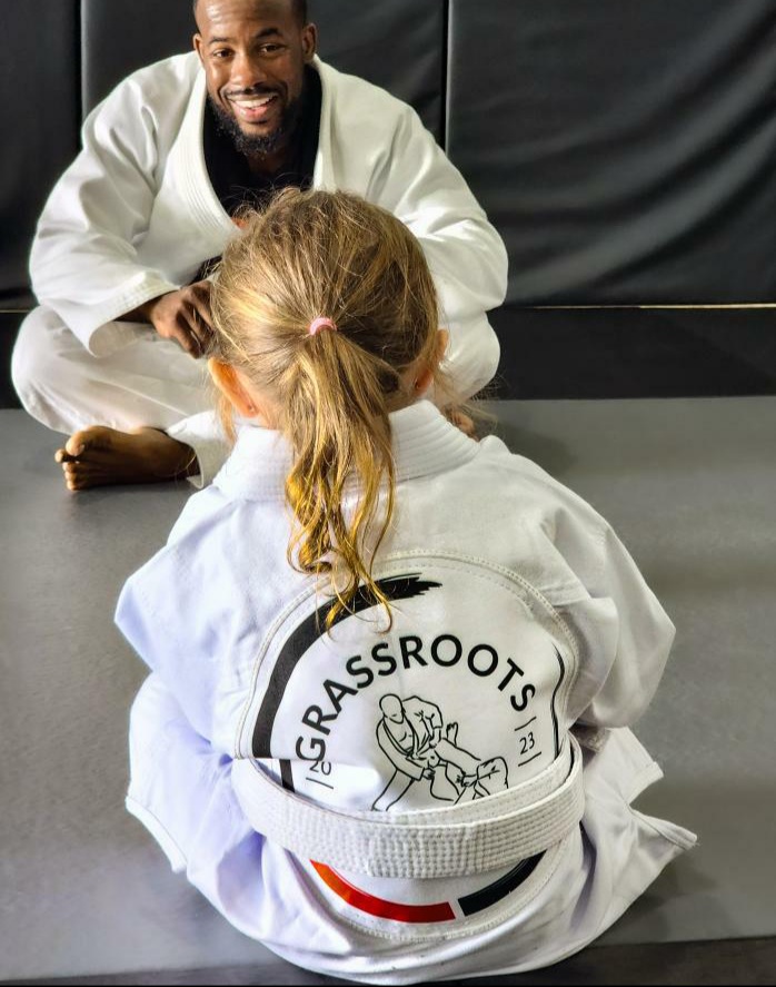 Small child in academy gi listening to instructor.